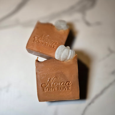 Photo of Noraa Body Love’s White Pumpkin Bar Soap with warm fall tones and creamy texture.