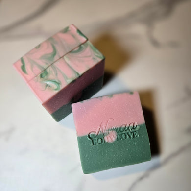 Two soap bars with 'Noraa Body Love' branding on a white background