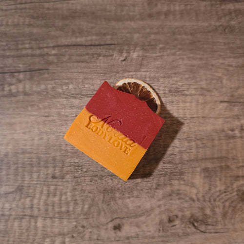 red and orange soap with a dried orange slice embedded on top